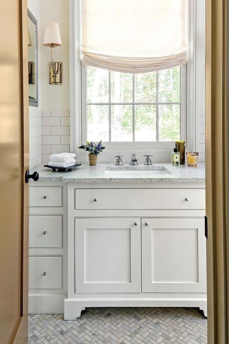 a bathroom with two sinks and a window