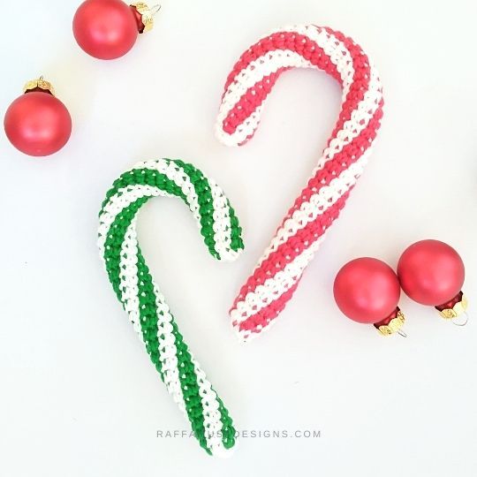 some candy canes and ornaments on a white table