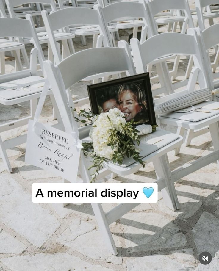 a memorial display with white chairs and flowers in front of a couple's face