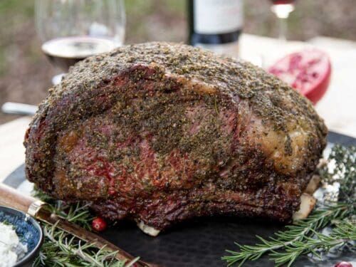 a large piece of meat sitting on top of a black plate