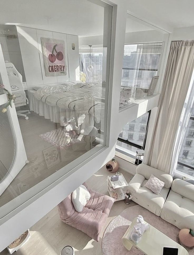 a living room filled with white furniture and lots of windows