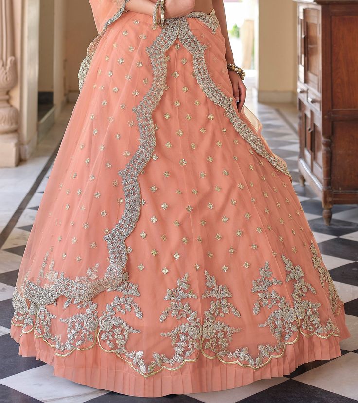 COLOR : Salmon Peach FABRIC : Top (Blouse) - Soft Net, Bottom (Lehenga) - Soft Net, Dupatta - Soft Net WORK : Metallic Thread Embroidery, Zari Work, Cutwork, Sequins, Motifs, Lace Border OCCASION : Wedding, Reception, Sangeet, Engagement READY-TO-WEAR : NoSTITCHING : Available as semi-stitched fabric, can be stitched using standard size option (+$30). Note: There might be a slight color variation due to lighting and flash used during photoshoot. The bright shade seen is the best closer view of f Salmon Peach, Peach Fabric, Holiday Promotions, Embroidered Wedding, Wedding Lehenga, Zari Work, Net Dupatta, Thread Embroidery, Lace Border