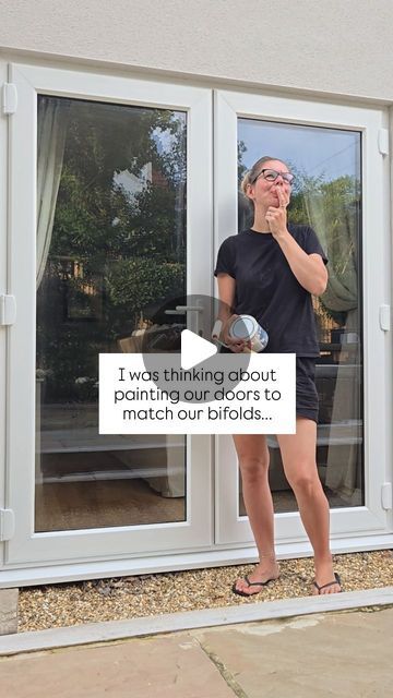 a woman standing in front of a sliding glass door talking on her cell phone with the caption i was thinking about painting doors to match our bifolds