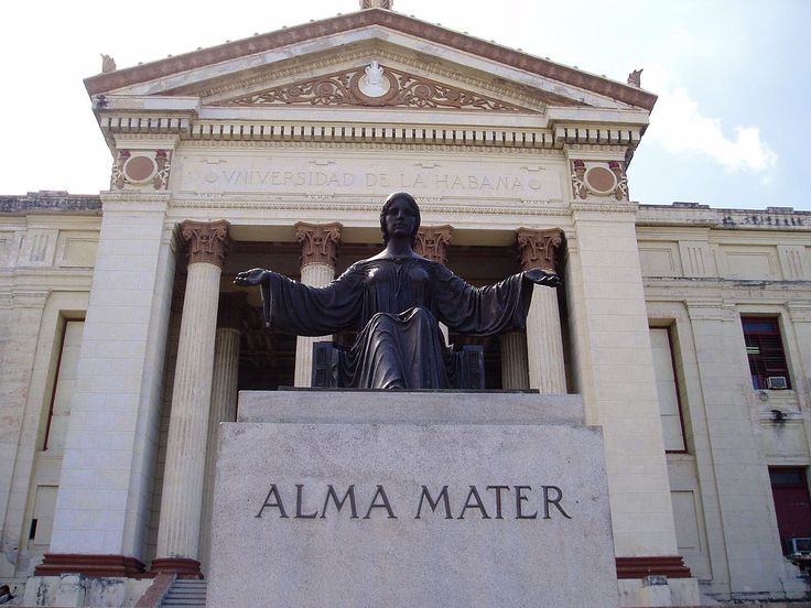 there is a statue in front of the building that says alma mater on it