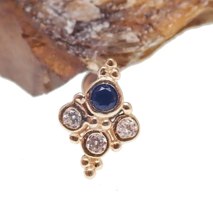 This 14k Gold Sapphire Blue Cluster Push Fit contains real gold with no fake plating! It's easy to bend but remains sturdy once in. Note that the post is titanium but the top is real gold!Materials - 14k real gold with Sapphire Blue CZ and Crystal Clear CZ stonesLength - 6mm, 8mm, 10mmSize - Stone Sizes - 2.5mm, 3mmGauge - Post: 14g, 16g, 18g, 20gSold in Singles Gold Sapphire Jewelry Stamped 14k, Blue Tarnish-resistant Jewelry For Anniversary, Blue 14k Gold Tarnish-resistant Jewelry, 14k Gold Blue Jewelry With Diamond Accents, 14k Gold Jewelry With Blue Diamond Accents, 14k Gold Jewelry With Diamond Accents In Blue, Tarnish Resistant 14k Gold Blue Jewelry, 14k Gold Sapphire Jewelry With Bezel Setting, Sapphire Jewelry With Bezel Setting In 14k Gold