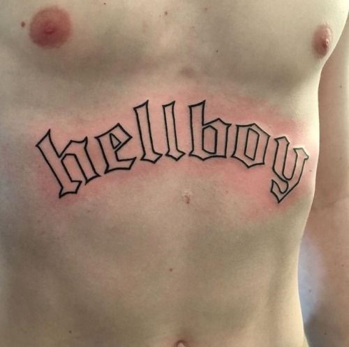 a man's chest with the word hellboy written in cursive font