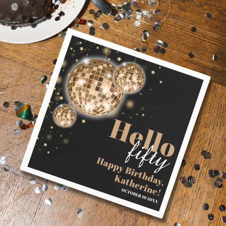 a birthday card with disco balls and confetti around it on a wooden table