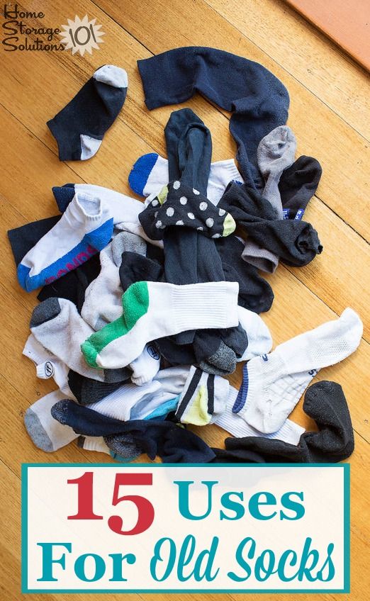 a pile of socks sitting on top of a wooden floor next to a sign that says 15 uses for old socks