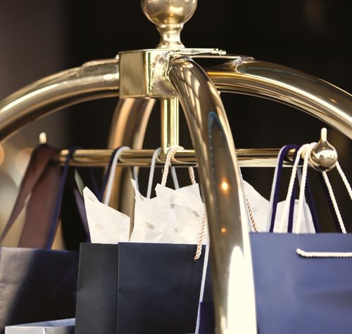 several shopping bags are hanging on a rack