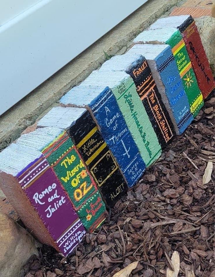 a row of books sitting on top of a pile of mulch next to a white door