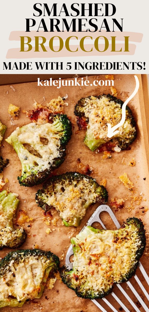 broccoli stuffed with parmesan cheese on a wooden cutting board next to a fork