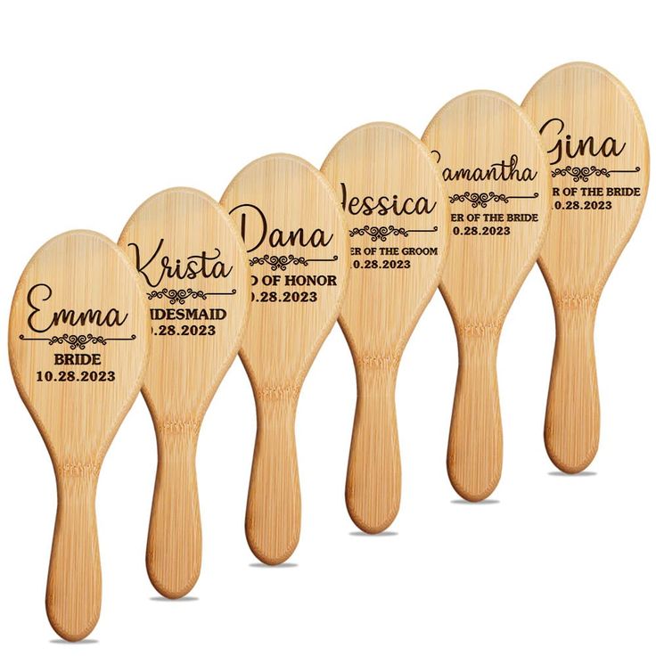 four wooden paddles with names on them