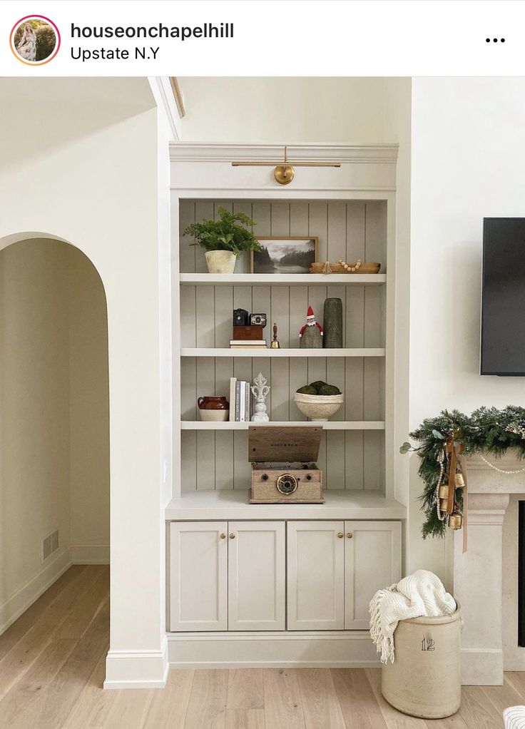 a living room filled with furniture and a flat screen tv on top of a fireplace