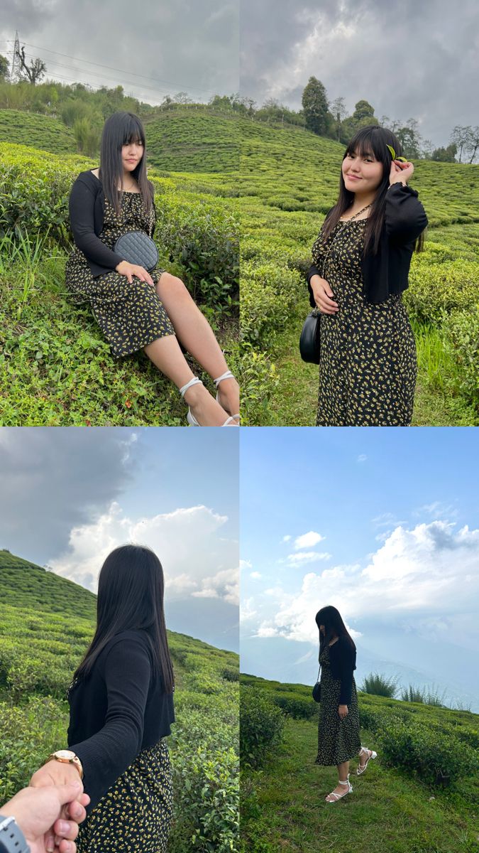 two women are sitting in the grass and one is holding her hand