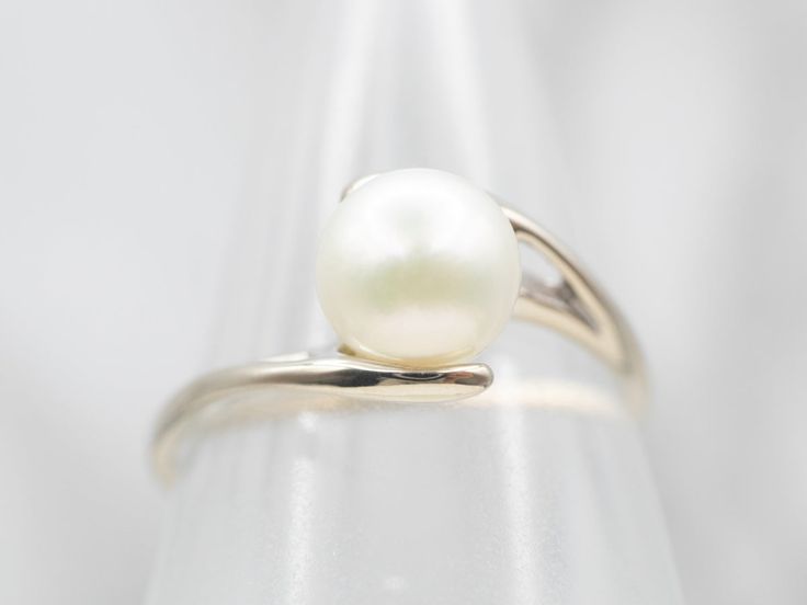 This beautiful, bypass-designed white gold ring is an amazing and feminine statement ring! The big, luscious pearl is cultured, measuring 7.7mm round and with lovely, soft pink iridescence. This would make a perfect piece as a right-hand ring on a Wedding Day - something that could be worn over and over for years to come.Metal: 14K White GoldGem: PearlGem Measurements: 7.4 mm, RoundRing Size: 9.50Marks: "\S/ 14K" Stamped on the inside band Classic White Bypass Ring For Formal Occasions, Formal White Open Bypass Ring, Formal White Bypass Ring, Elegant White Bypass Ring, Elegant White Bypass Open Ring, Elegant White Open Bypass Ring, White Bypass Wedding Ring, Bypass Ring, Pocket Watch Chain