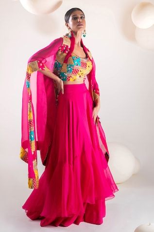 Fuchsia pink batwing sleeves cape with persian patchwork adorned with sequin highlights. Paired with a patchwork and hand embroidered blouse and a ruffled skirt. - Aza Fashions Pink Silk Sequined Set, Pink Silk Set With Sequins, Pink Sequined Silk Set, Pink Choli With Cape Sleeves For Reception, Pink Lehenga With Dupatta And Cape Sleeves, Festive Pink Dress With Cape Sleeves, Pink Dupatta Set With Cape Sleeves, Traditional Pink Dress With Cape Sleeves, Pink Cape Sleeves Set With Dupatta