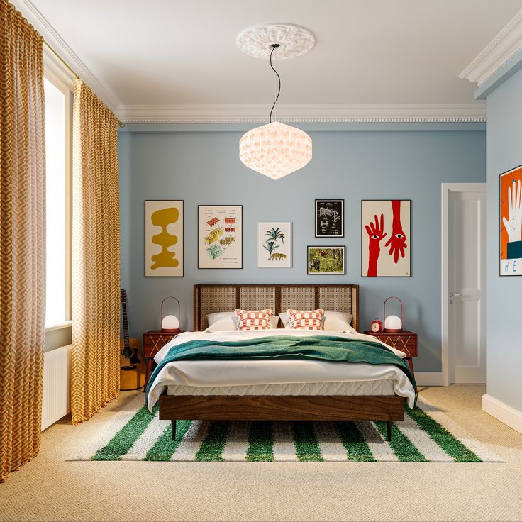 a bedroom with blue walls and pictures on the wall