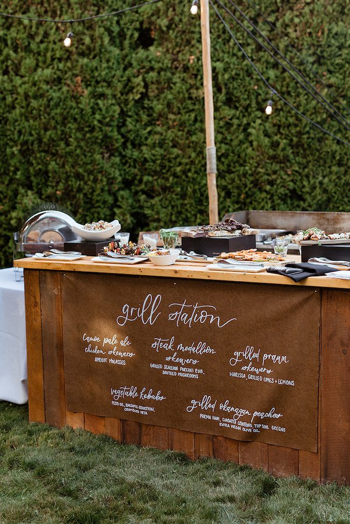 an outdoor buffet is set up in the grass