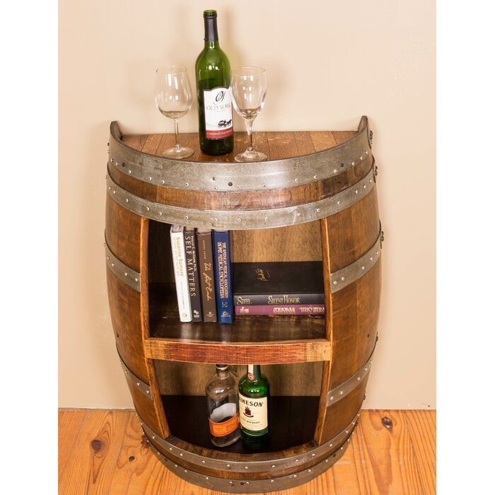 a wooden barrel shelf with wine glasses and books