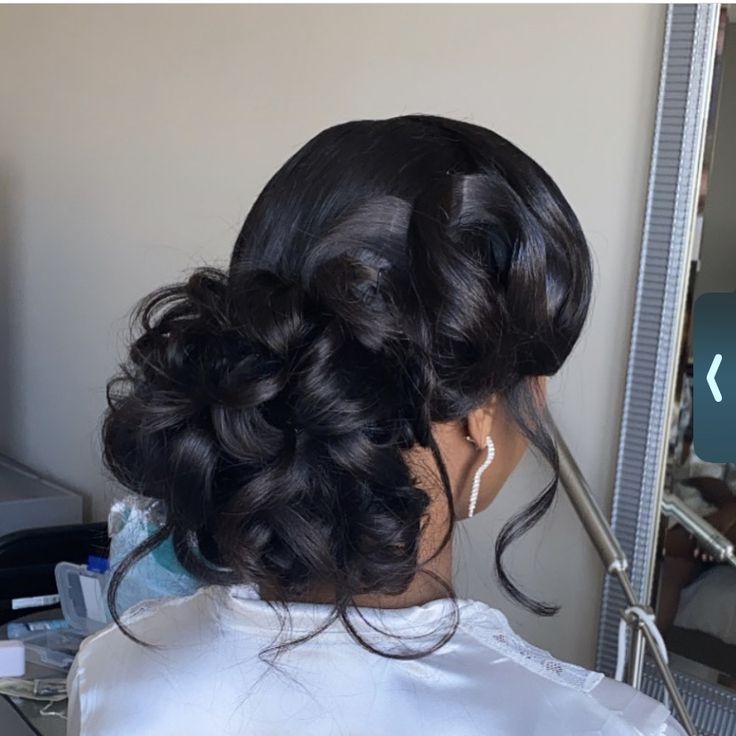 a woman getting her hair done in front of a mirror