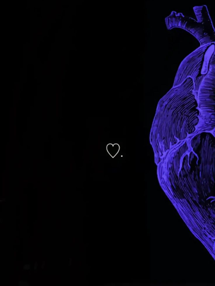 a blue heart in the dark with a small white heart on it's side