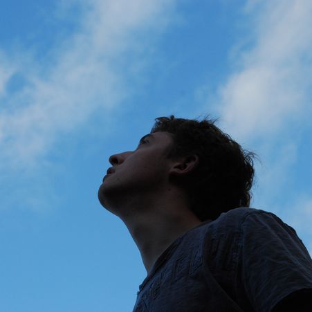 a man is looking up at the sky