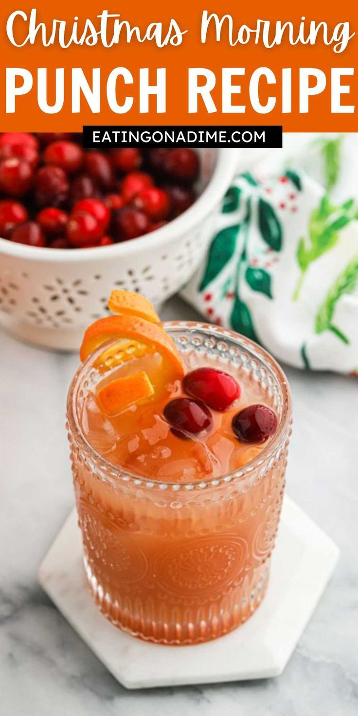 christmas morning punch recipe with oranges and cranberries in the background, on a white plate