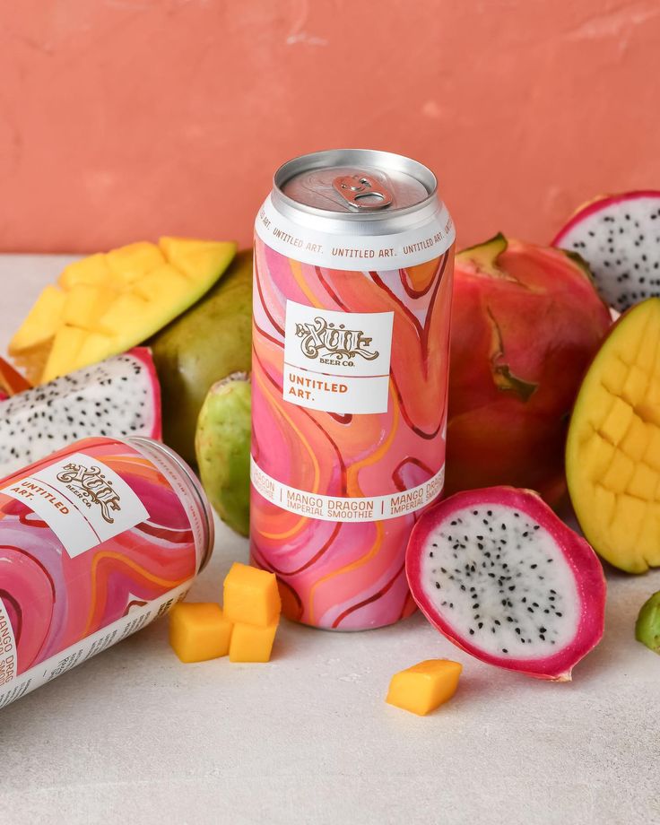 a can of juice next to some fruit