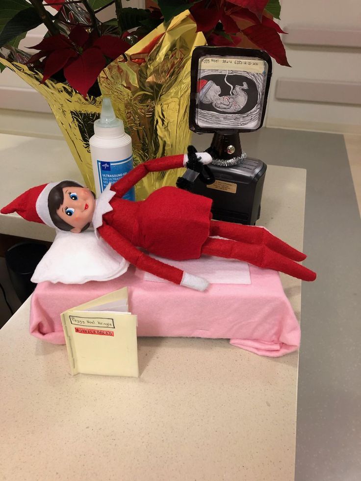 an elf is lying on the desk with his feet up