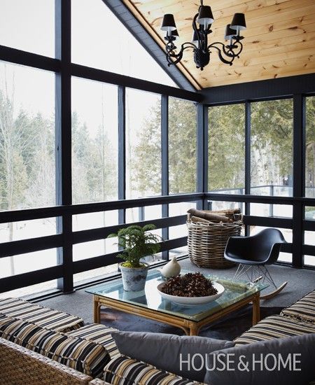 a living room filled with furniture and lots of windows