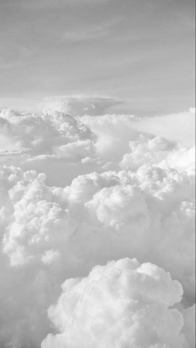 black and white photograph of clouds taken from an airplane