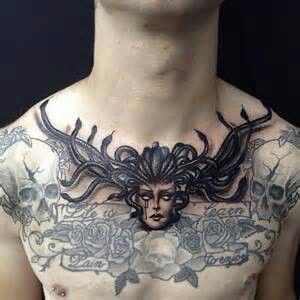 a man with tattoos on his chest is wearing a skull and flower head tattoo design