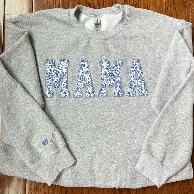 The perfect personalized gift for all of the moms in your life . . . . . . . . . . . . . . . . . Cozy sweatshirt with "Mama" hand sewn in place with fabric of your choice (see last photo). If you would like a different fabric, please message with specifications of what you are interested in. Option for embroidery of up to four letters on the right sleeve. Letters will be in white, separated by a heart in a color that correlates with the fabric chosen for the appliqué. Customizable Cotton Sweatshirt For Loungewear, Mother's Day Crew Neck Sweatshirt With Letter Embroidery, Personalized Cotton Crew Neck Sweatshirt, Personalized Cotton Sweatshirt For Winter, Personalized Long Sleeve Sweatshirt, Personalized Cotton Sweater For Winter, Customizable Cotton Fall Sweater, Customizable Cotton Sweater For Fall, Customizable Casual Sweatshirt For Gifts