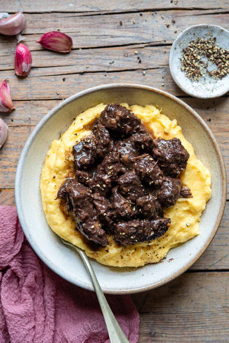 red wine beef stew in a bowl with mashed potatoes