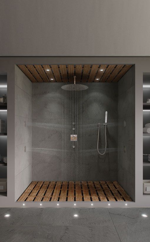 an open shower with wooden flooring in a modern style bathroom, surrounded by shelves and shelving