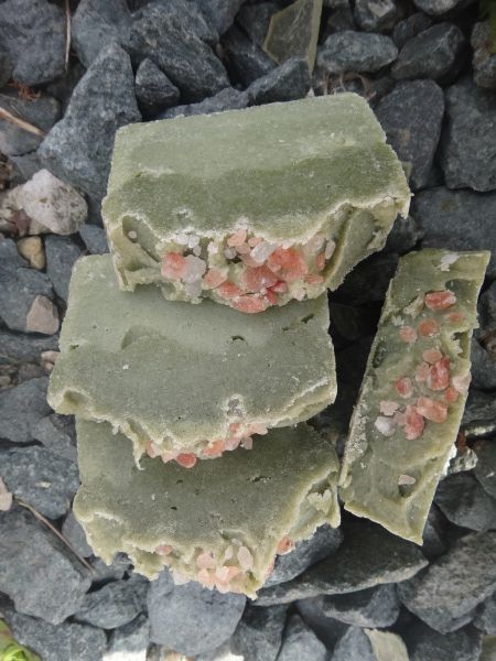 three pieces of soap sitting on top of some rocks