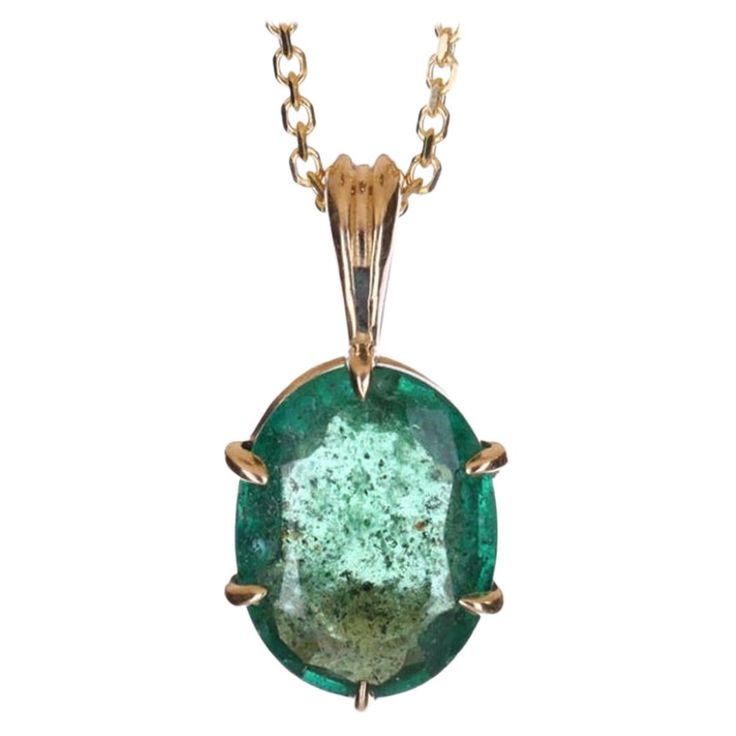 Displayed is a classic and unique emerald solitaire necklace set in 14K yellow gold. This gorgeous solitaire pendant carries a full 1.88-carat emerald in a six-claw prong setting. Fully faceted, this gemstone showcases very good shine, rare dark green color, great size, and clarity. An ideal solitaire, perfect for everyday use! Setting Style: Solitaire - Prong Setting Material: 14K Yellow Gold Gold Weight: 1.3 grams Main Stone: Emerald Shape: Oval Cut Approx Weight: 1.88-carats Color: Green Clarity: Translucent Luster: Very Good Origin: Zambia Treatment: Natural, Oiling Suggested Retail price $3800 Solitaire Necklace, Claw Prong, Solitaire Necklaces, Solitaire Pendant, Zambia, Gold Gold, Oval Cut, Gold Pendant, Prong Setting