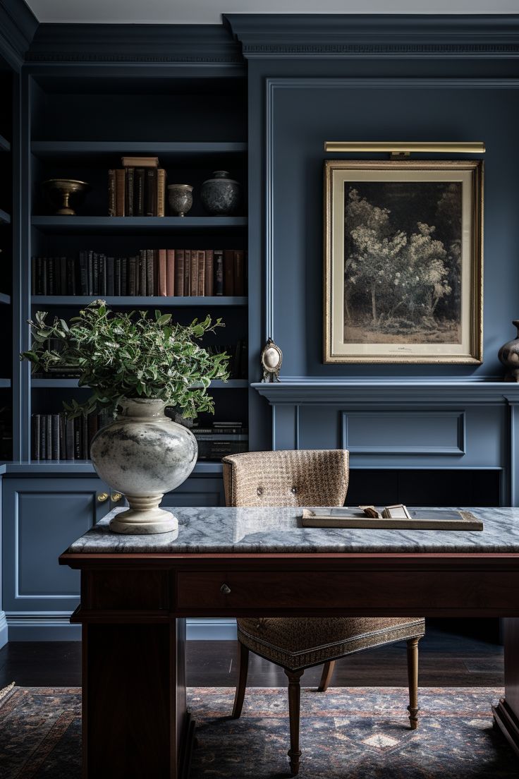 a room with blue walls and bookshelves has a marble top desk in the center