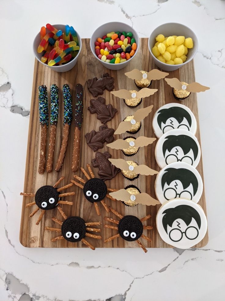 a wooden cutting board topped with halloween treats