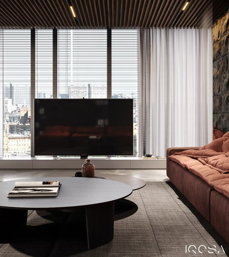 a living room with couches and a large flat screen tv in the middle of it