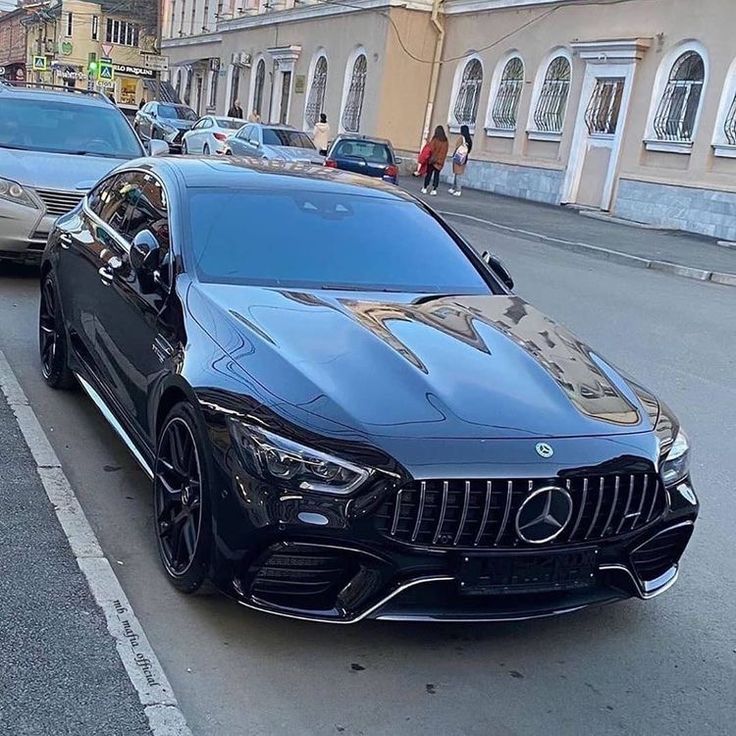 a black car parked on the side of a road