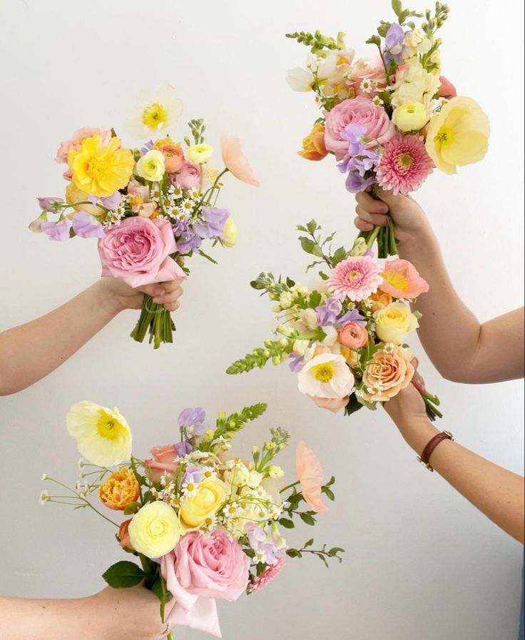 four hands holding bouquets of flowers against a white background with text overlay that reads, how do you choose the best flower arrangement for your wedding?