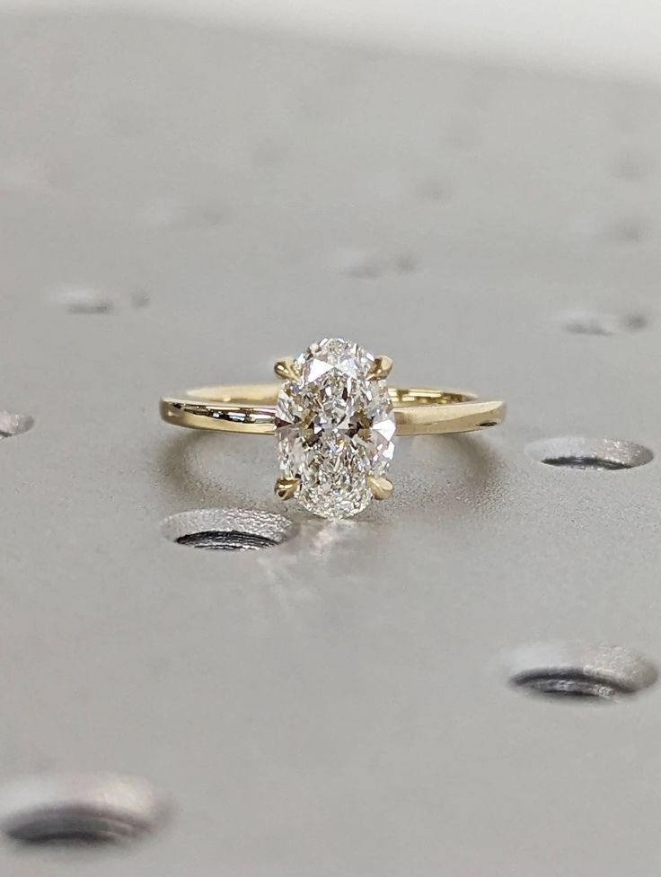 a diamond ring sitting on top of a table