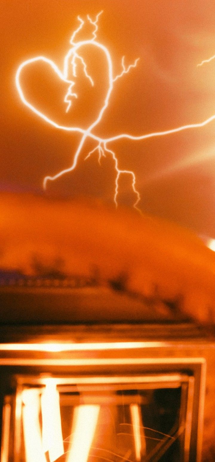 a toaster oven sitting on top of a counter under a lightening cloud with a heart drawn on it