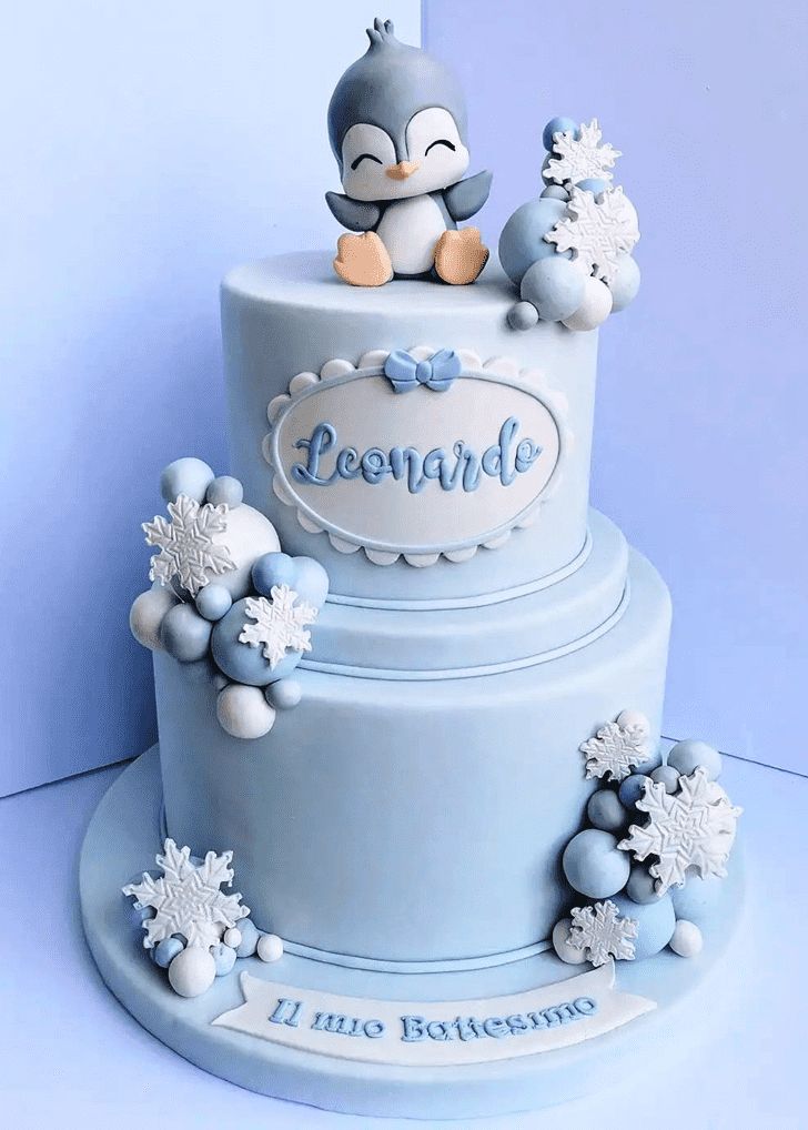 a blue cake with snowflakes and a bird on top that says courre