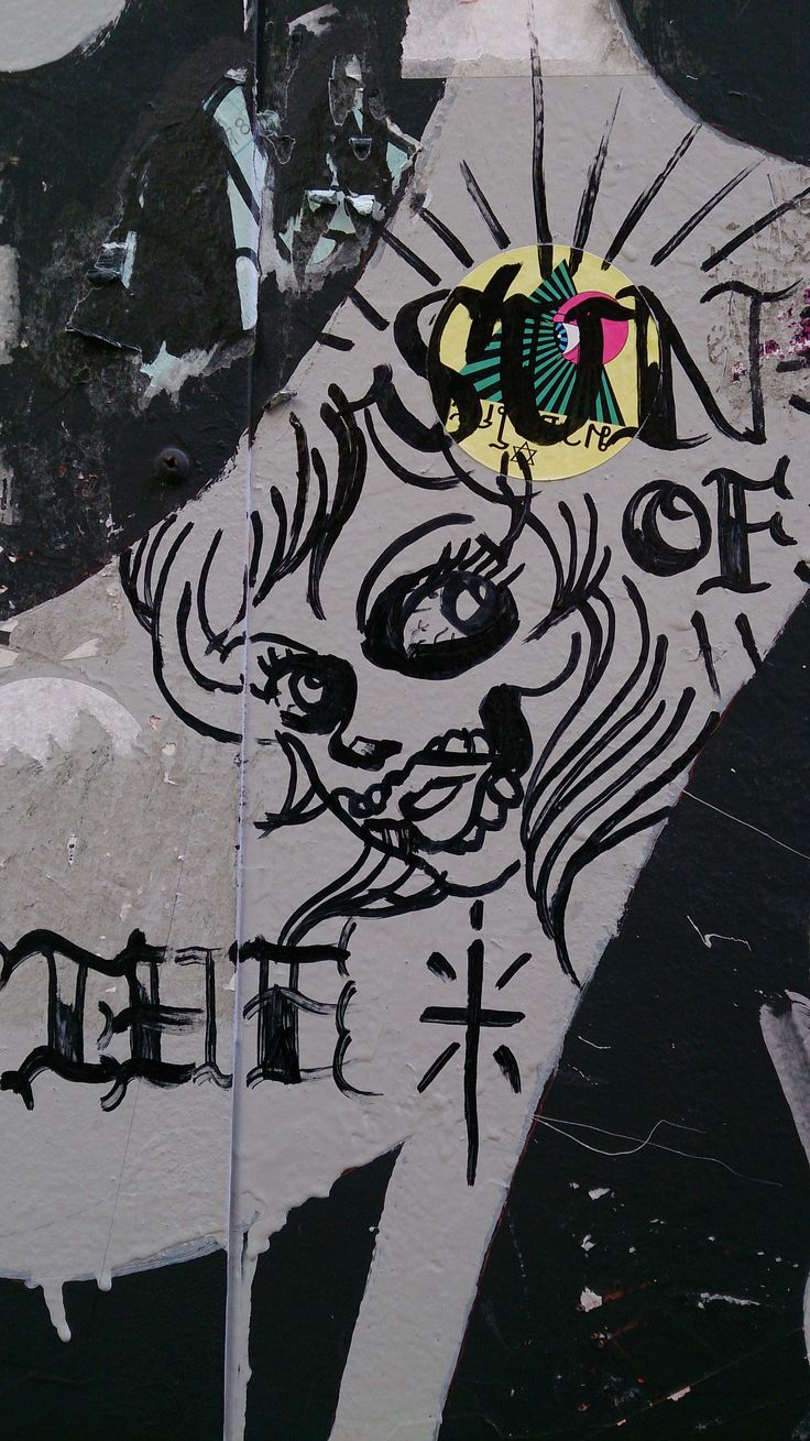 graffiti on the side of a building with an image of a cat