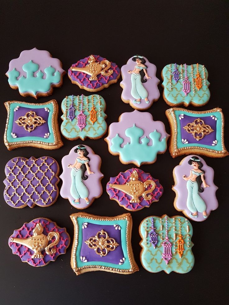 decorated cookies are arranged in the shape of princesses