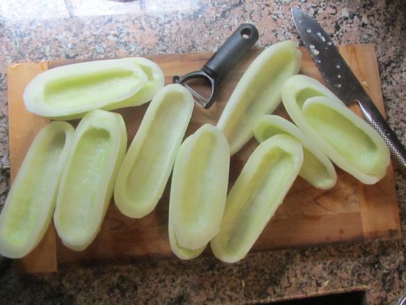 sliced green beans on a cutting board with a knife