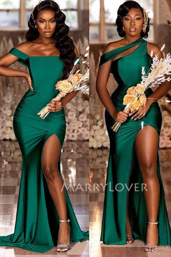 two women in green dresses posing for the camera, one is holding flowers and the other has