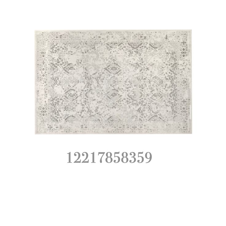 the area rug is shown in white and grey colors with an ornate design on it